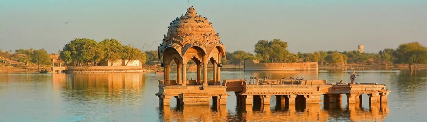 Sandstone ghats and Tilon-ki-Pol gateway at Gadisar Lake Jaisalmer