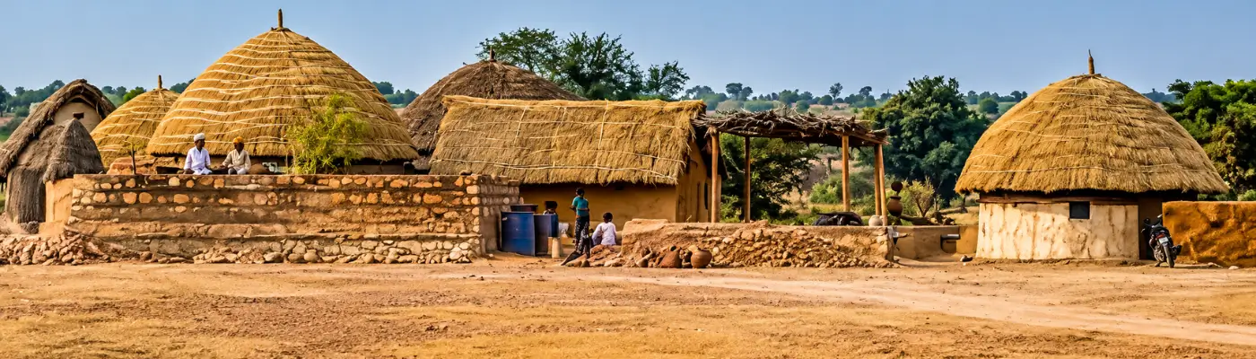 Rural desert village near Jaisalmer with mud homes and dunes